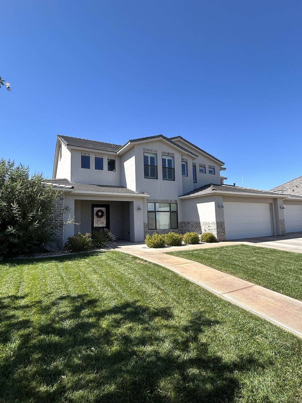 Stucco home with cleaned upstairs windows